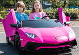 Two children sit in a Pink 24V/180W Lamborghini SV Limited XXL Edition with butterfly doors open. The girl holds the steering wheel while the boy enjoys their adventure at up to 10MPH, embodying Kids VIP fun on a sunny day.