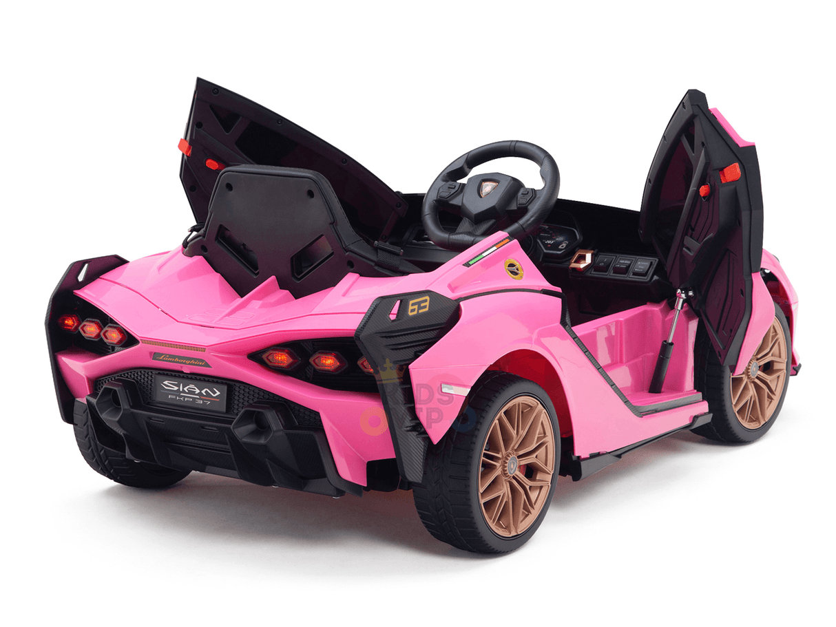 The Official 12V Sport Edition Lamborghini Sian Kids Ride-On Car features a pink exterior, open design, detailed headlights, sleek black interior, brown wheels, an open hood and doors with controls for an authentic driving experience.
