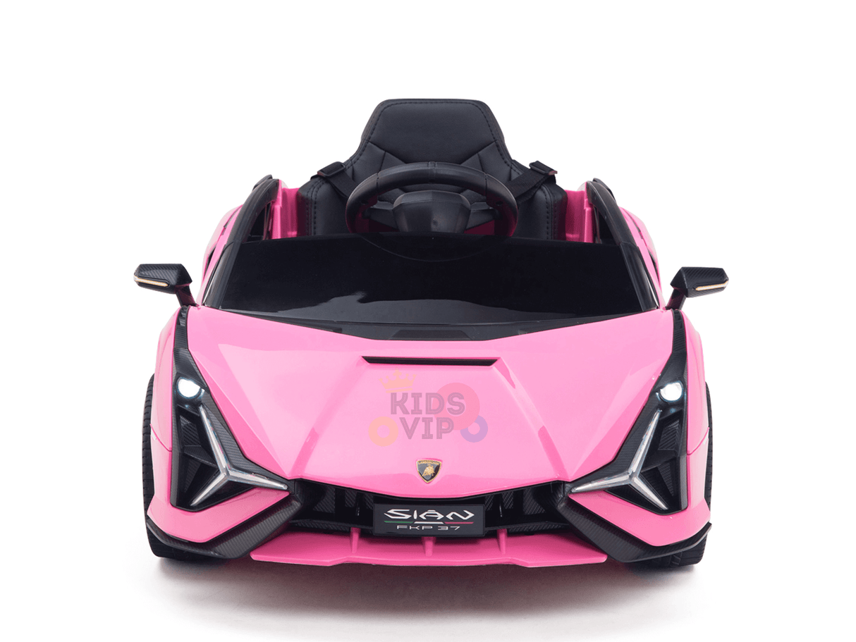 The Official 12V Sport Edition Lamborghini Sian Kids and Toddlers Ride-On Car features a sleek pink design with black accents, LED headlights, and a KIDS VIP logo on the hood. It boasts an open cockpit with a black steering wheel for an exhilarating ride experience.