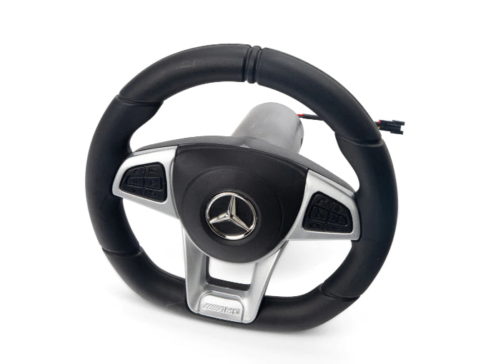 The black and silver steering wheel, adorned with the Mercedes logo and multiple spoke buttons, promises an exhilarating ride-on car experience. On a white background, this detail from the two-seater Mercedes GLC exudes luxury and precision: Enhance Your Driving Experience with a 2 Seater Mercedes GLC Steering Wheel.