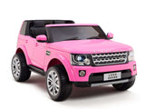 This pink ride-on Land Rover for kids features black seats, silver wheels, realistic details like a front grille and headlights, and a Land Rover number plate. The 12V Discovery model shines against a white background with a high-quality front axle for smooth adventures.